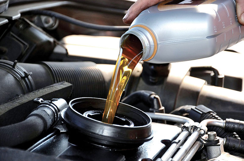 Engine oil being poured during a service