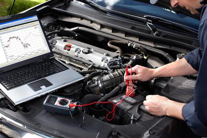 Technician running a diagnostic check with a laptop